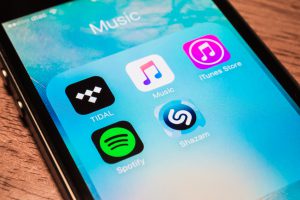 Bangkok, Thailand - July 2, 2016 : Apple iPhone5s showing its screen with popular music applications.